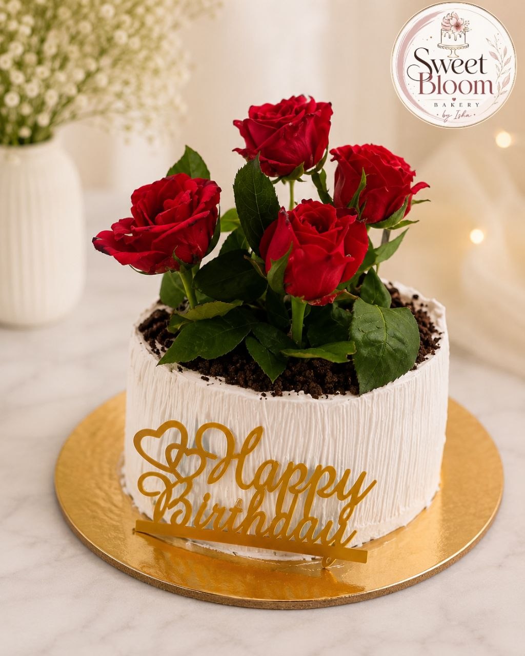 White birthday cake topped with fresh red roses and gold Happy Birthday topper — Sweet Bloom Bakery, Asansol